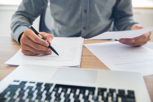 businessman-checking-documents-table