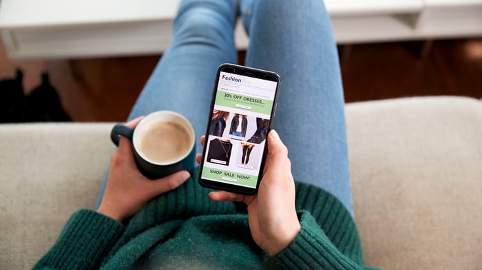 close-up-of-woman-shopping-for-clothes-online-usin-2024-10-19-13-23-00-utc