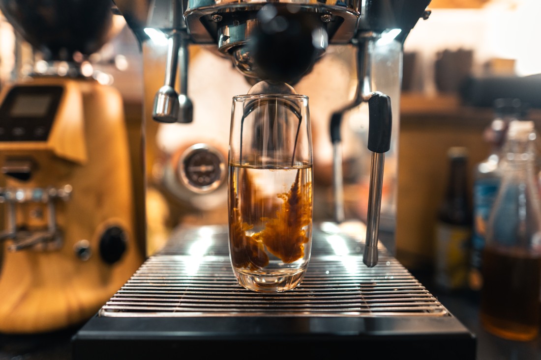 Fresh coffee beverage being prepared with an espresso machine