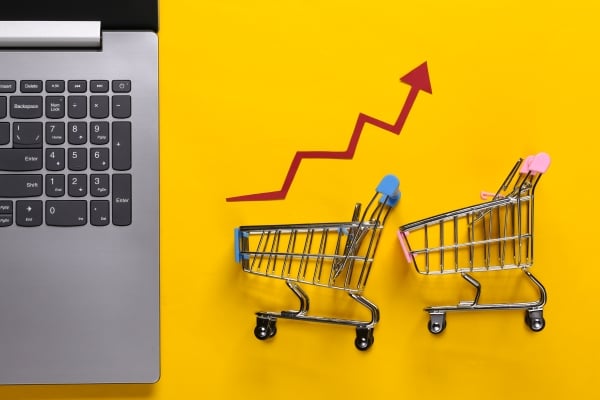 concept-rising-sales-online-business-laptop-shopping-trolley-with-growth-arrow-yellow