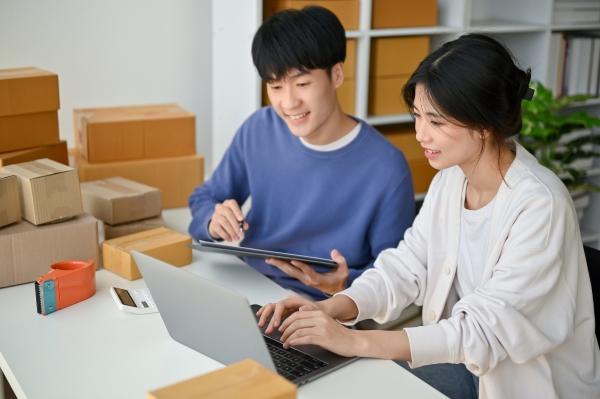 couple-is-working-their-home-office-checking-customer-orders-website-together