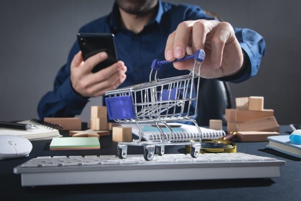 man-using-smartphone-showing-shopping-cart-online-shopping